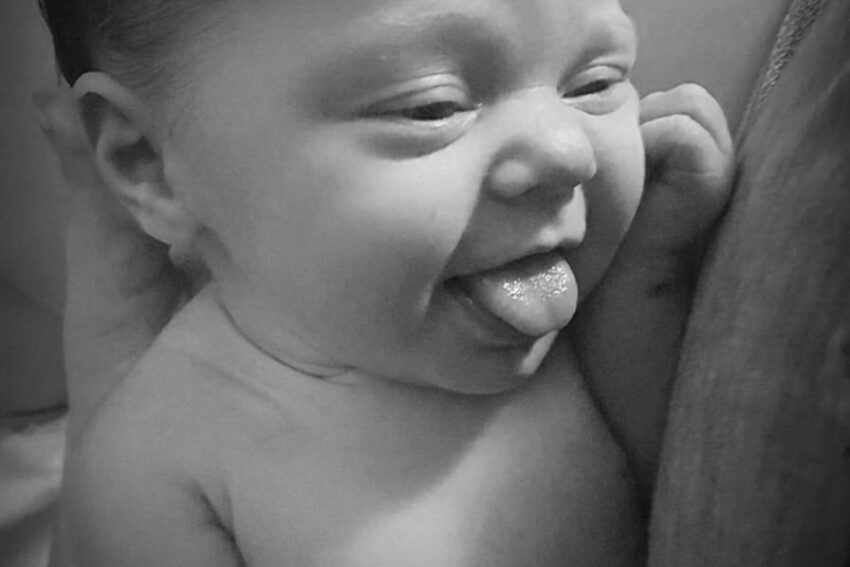 Baby with tongue sticking out for tongue tie consultation