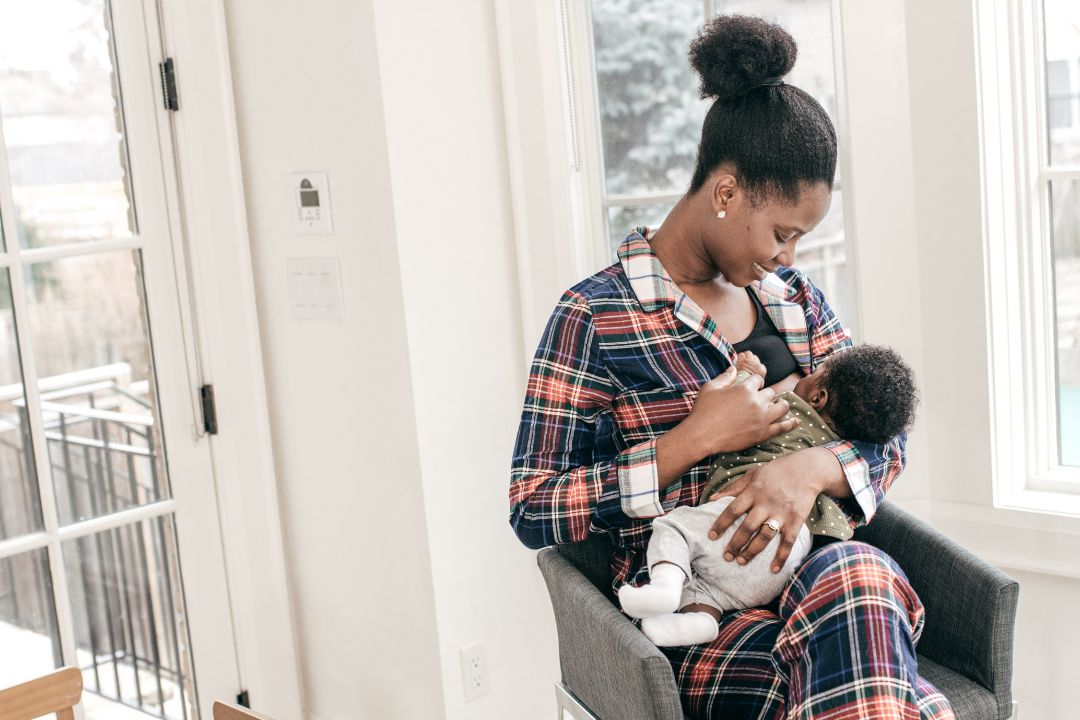 Woman breastfeeding at home